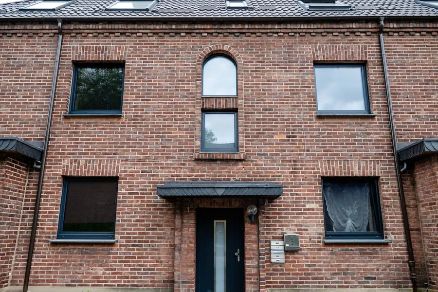 Backsteinhaus mit neuen schwarzen Fenstern
